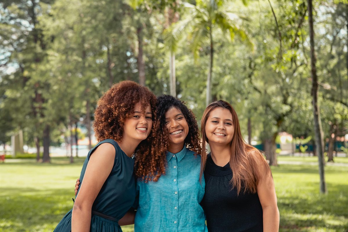 Three smiling women enjoying time outdoors